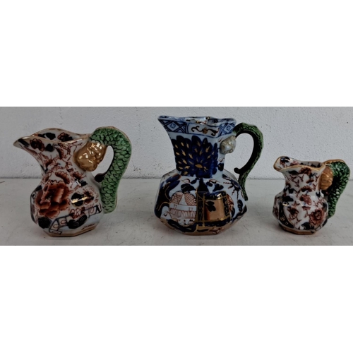 234 - Set of 3 antique Mason's Ironstone jugs. The jugs feature dragon handles and intricate floral and ge... 