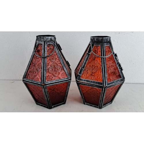 241 - Pair of interictally designed tealight lanterns with embossed red glass panels, housed in distressed... 