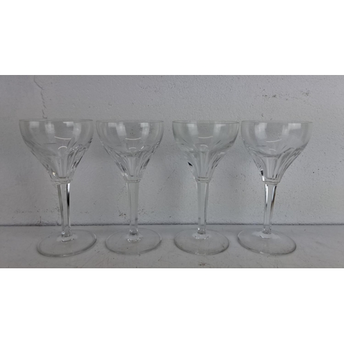 244 - Set of four clear crystal wine glasses with elegantly cut bowls and long stems.