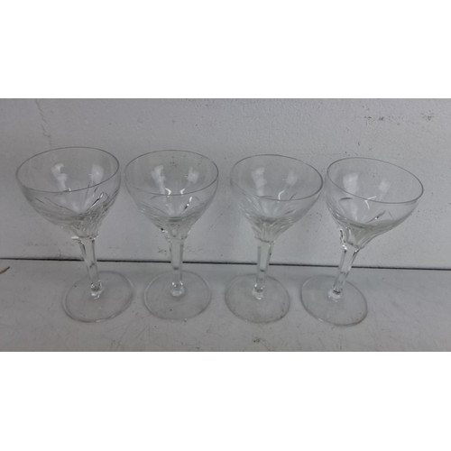 244 - Set of four clear crystal wine glasses with elegantly cut bowls and long stems.