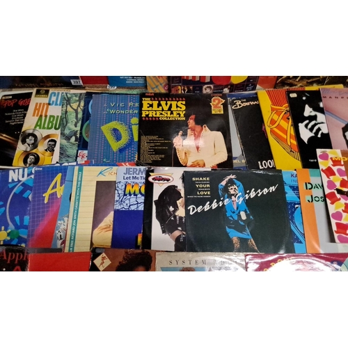 397 - A lot of vintage vinyl records featuring various artists and genres. Includes notable albums from El... 