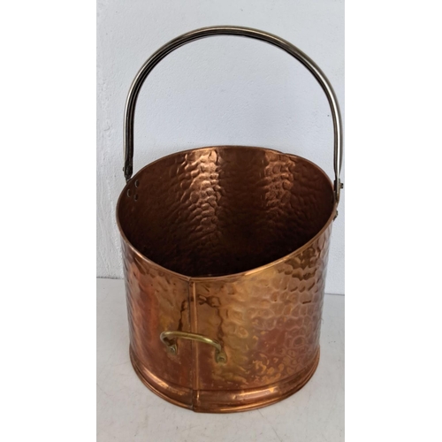 424 - Hammered copper bucket with brass handle and rivets, featuring a sturdy steel handle.