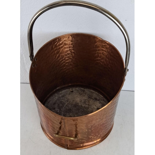 424 - Hammered copper bucket with brass handle and rivets, featuring a sturdy steel handle.