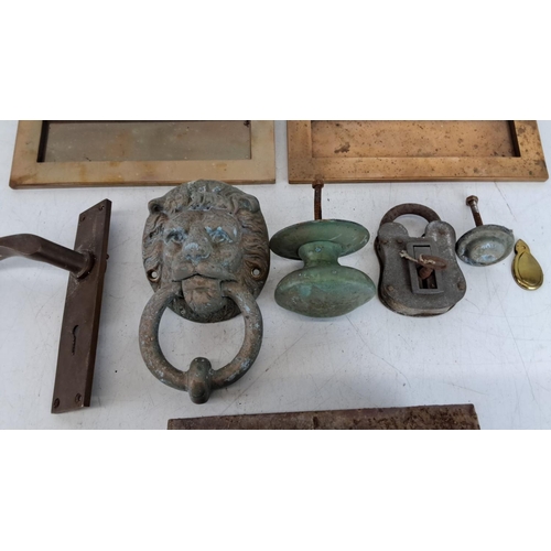 431 - Collection of antique brass and bronze door furnishings including a lion-head door knocker, letter s... 