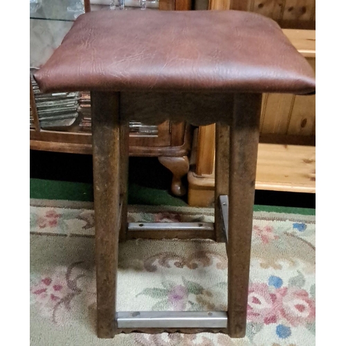 447 - Vintage wooden stool with brown upholstered seat. Features solid construction with four legs and cro... 