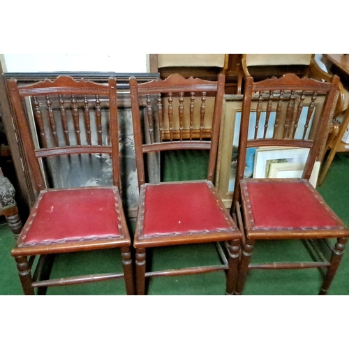 460 - Set of three late Victorian oak chairs with spindle backs and red leatherette seats.