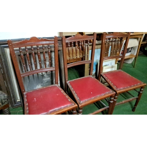 460 - Set of three late Victorian oak chairs with spindle backs and red leatherette seats.