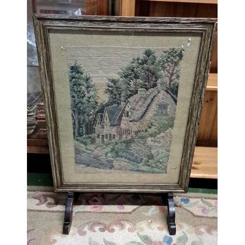 461 - Framed needlepoint scene depicting a charming cottage amidst a wooded landscape, housed in a rustic ... 