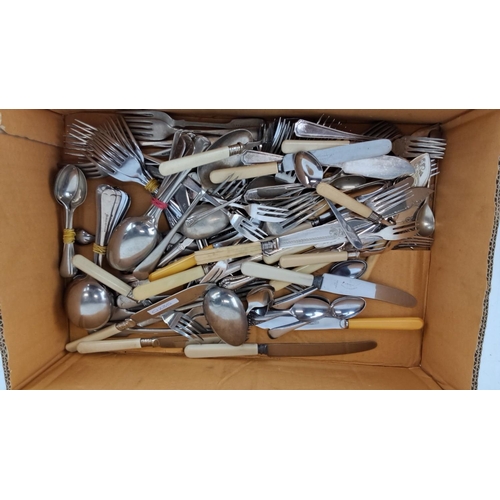 467 - Vintage cutlery lot including forks, spoons, and knives. Variety of handles, some with cream-colored... 