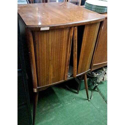 474 - Mid-Century Modern wooden cabinet featuring tambour doors and tapered legs. The cabinet’s interior p... 