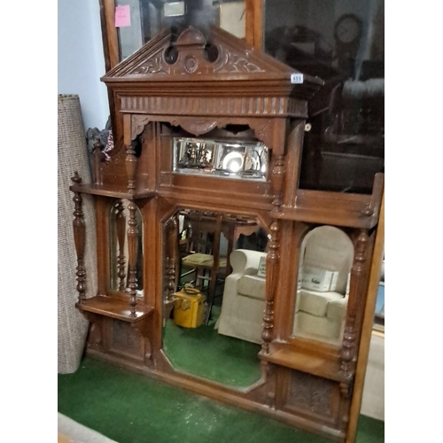 489 - Edwardian mahogany overmantel mirror with spindle columns and carved pediment. Features mirrored bac... 