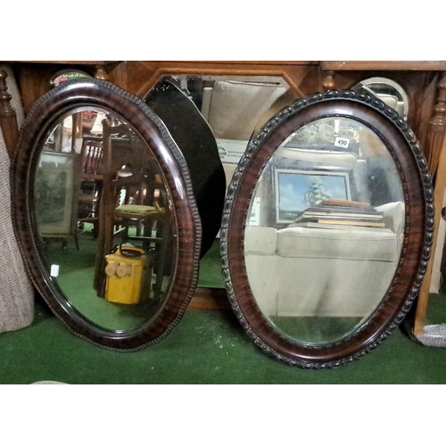 490 - Pair of antique oval mirrors with wooden frames. The product features intricate carved details. Like... 