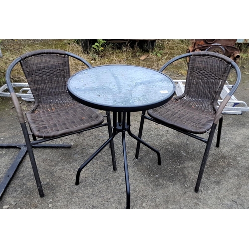 501 - Outdoor patio set with two wicker chairs and a round glass-top table. Features black metal frames. 7... 