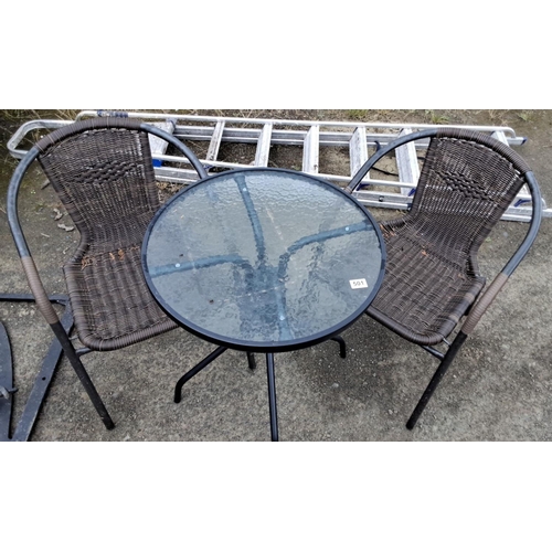 501 - Outdoor patio set with two wicker chairs and a round glass-top table. Features black metal frames. 7... 