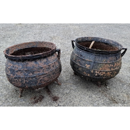 503 - Pair of antique cast iron cauldrons with handles, featuring a weathered patina. (Please note both po... 