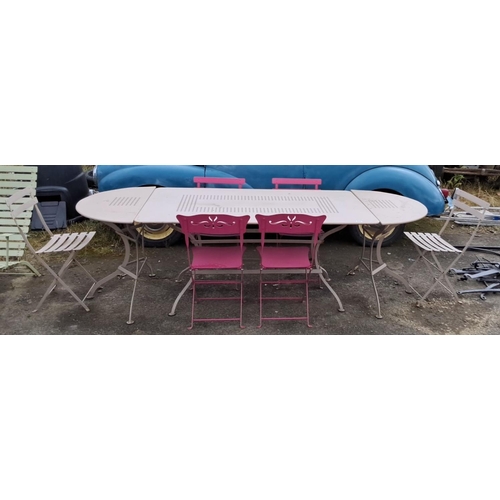 505 - Metal patio set with  extendable table, six folding chairs in neutral tones, and tasteful pink accen... 