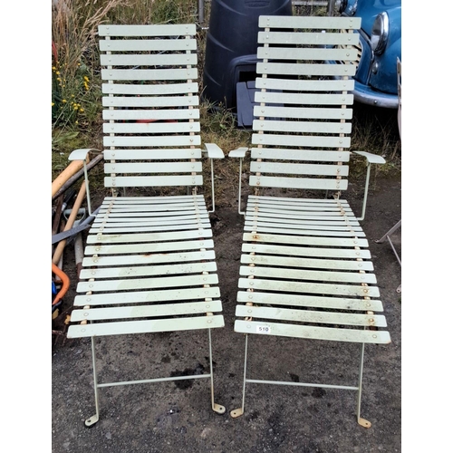 510 - Pair of vintage metal outdoor loungers with slatted design and adjustable backrests.