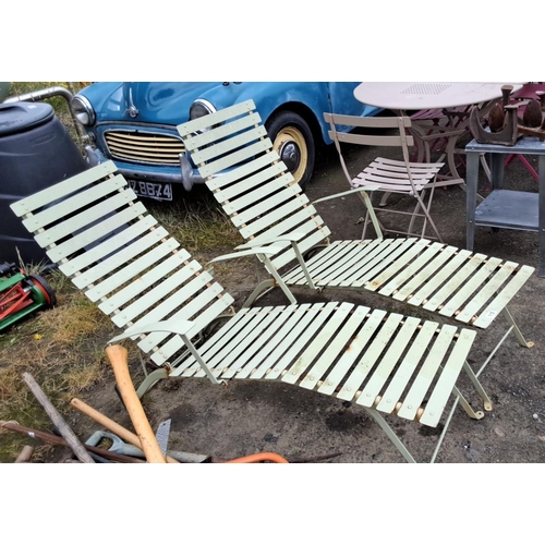 510 - Pair of vintage metal outdoor loungers with slatted design and adjustable backrests.