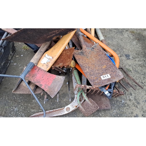 511 - Mixed lot of assorted gardening and farm tools. Includes shovels, rakes, hoes, and handles. Comes in... 