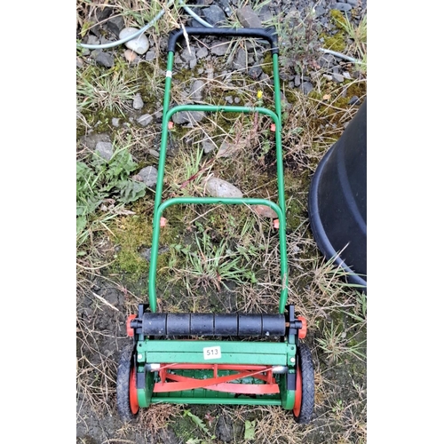 513 - Vintage manual lawn mower, featuring a green frame with red rotary blades.