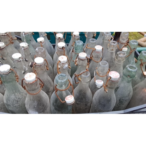 517 - Collection of 30 vintage glass bottles with ceramic stoppers. Features 