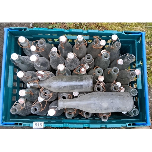 518 - Collection of 39 vintage glass bottles with ceramic swing-top closures, featuring embossed designs a... 