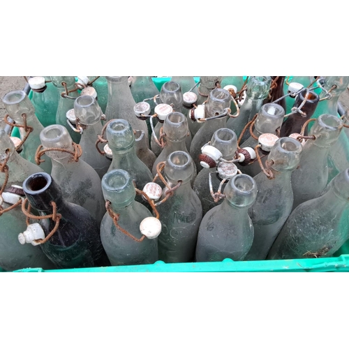 525 - 30 vintage glass bottles with ceramic swing-top caps, featuring various brewery labels.