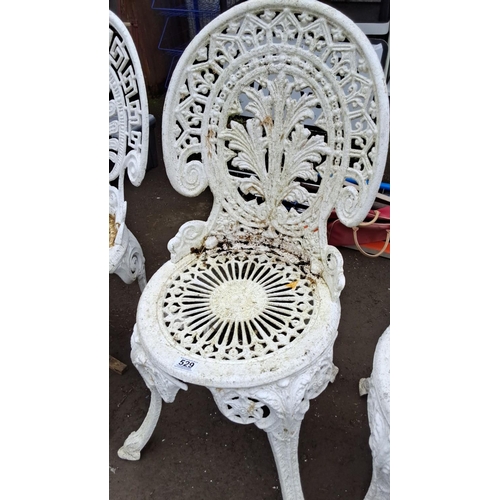 529 - Set of three vintage white cast aluminium garden chairs with intricate floral and geometric patterns... 