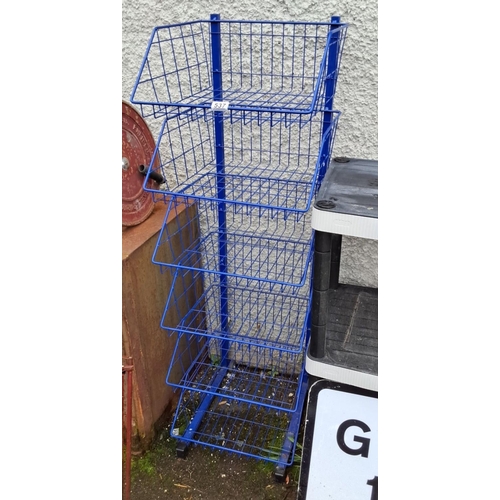 537 - Blue four-tier wire storage rack on wheels. This rack is made of sturdy metal wire with a bright blu... 