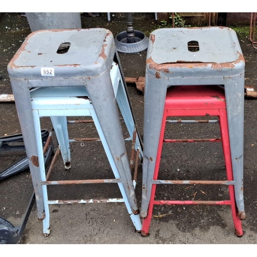 552 - Set of four vintage metal stools in assorted colors: two gray, one light blue, and one red.