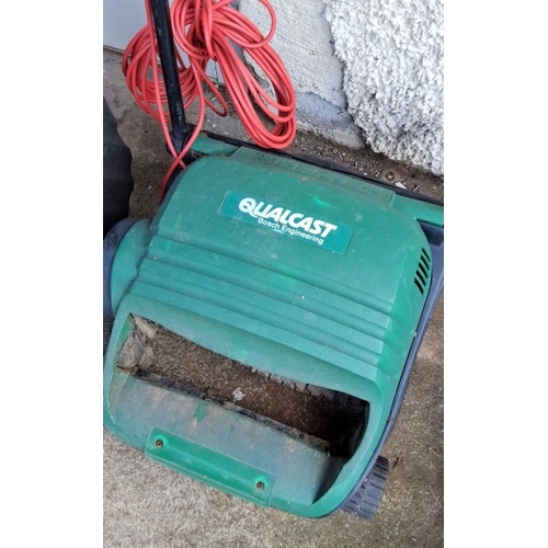 562 - Qualcast Bosch Engineering electric lawn mower with collection box and orange extension cord.