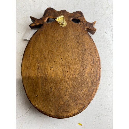 138 - Oval portrait miniature with a gold gilt frame and ribbon crest. Represents a gentleman in formal at... 