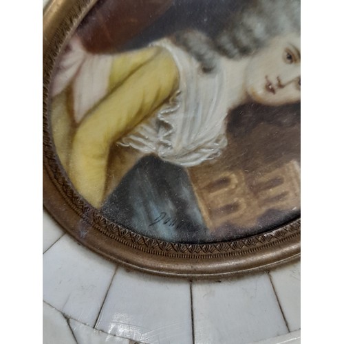 147 - Miniature French hand painted portrait on porcelain, set in a bone and tortoiseshell frame, measurin... 