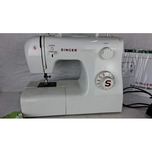 10 - Singer Tradition sewing machine, model 2250, comes with a foot pedal, an instruction manual, and fab... 