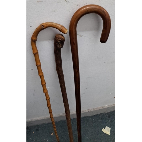 2 - This lot includes a variety of walking sticks and umbrellas. There are wooden canes with curved hand... 