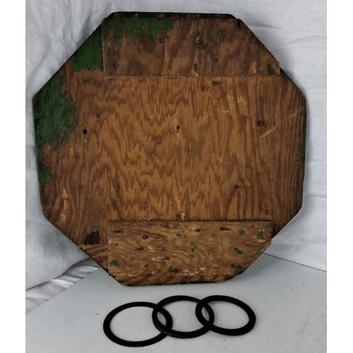 25 - A vintage wooden ring toss game board that comes with a painted target and three rings. It includes ... 