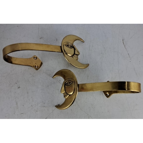 38 - Pair of Moonface Brass Curtain Tiebacks featuring a unique crescent moon and face motif. Features a ... 