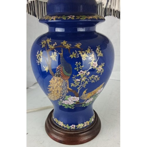 46 - A decorative table lamp with peacock design.