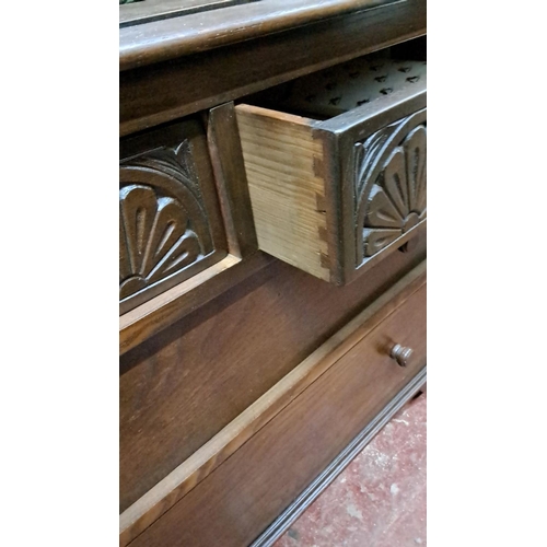 52 - Oak cabinet with leaded glass doors, carved detailing, and three lower drawers. From the Arts and Cr... 