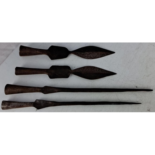 63 - Set of four antique iron spearheads featuring various designs and sizes from historical weaponry col... 