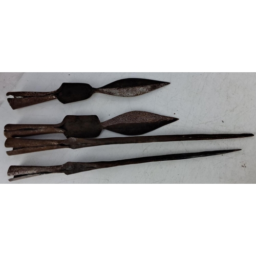 63 - Set of four antique iron spearheads featuring various designs and sizes from historical weaponry col... 