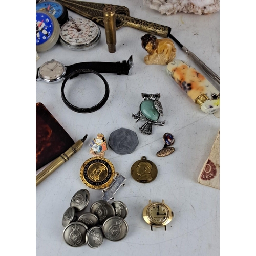 64 - A diverse mixed lot includes vintage watches, commemorative medallions, collectible brooches, an ant... 