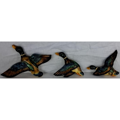 67 - A set of three vintage Rockalite 55 chalk wall plaques. Each piece showcases hand-painted ceramic du... 