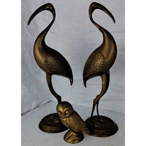 76 - Pair of brass heron figurines accompanied by a owl statue. They are intricately detailed, standing o... 