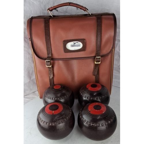 80 - A set of four lawn bowls comes with a carrying case. Each bowl is marked No. 67 with red and black d... 