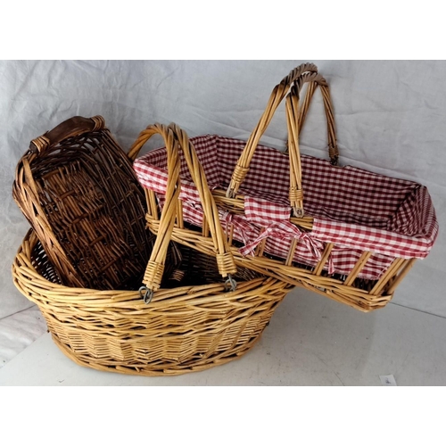 82 - Three woven wicker baskets, one with a red gingham fabric liner.