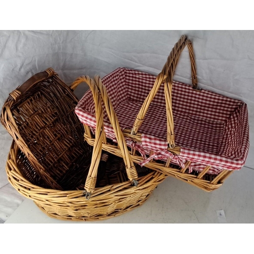 82 - Three woven wicker baskets, one with a red gingham fabric liner.