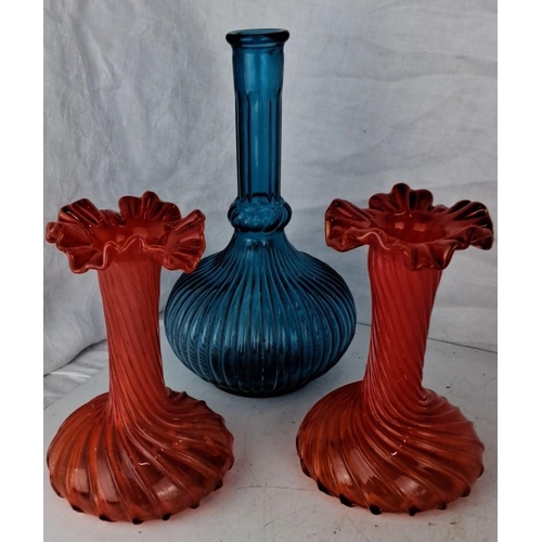 86 - This is a Mid-Century Modern glass set that includes a blue ribbed decanter and two orange/red ruffl... 