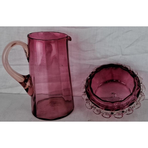 101 - Antique Ruby glass pitcher, measuring 19cm and bowl with ruffled edge. Both display a distinctive, d... 