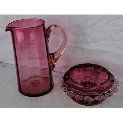 101 - Antique Ruby glass pitcher, measuring 19cm and bowl with ruffled edge. Both display a distinctive, d... 